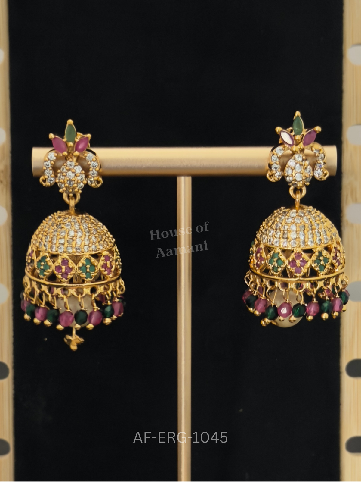 A crystal-topped dome with ruby and emerald diamond motifs hangs with faceted ruby-green beads and a pearl drop.