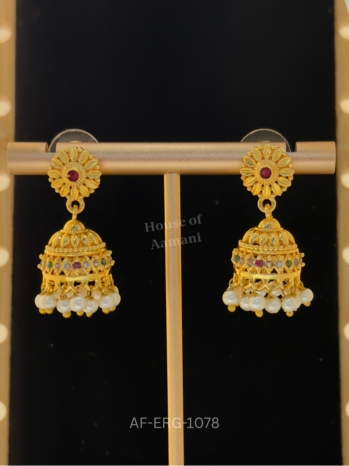 Petite gold flower tops with a ruby centre lead to compact filigree domes with a soft pearl fringe, ideal for everyday wear.