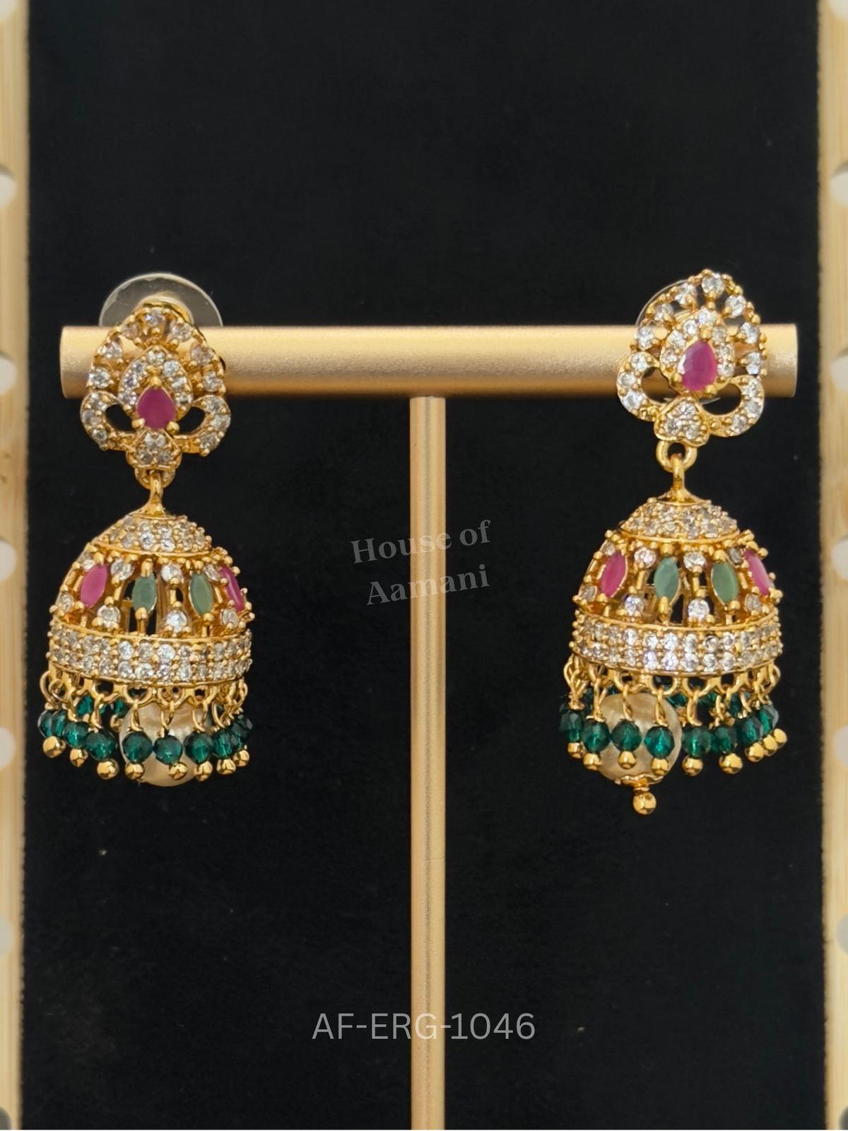 A crystal scroll top and marquise-studded dome are finished with deep green bead drops and a pearl centre.