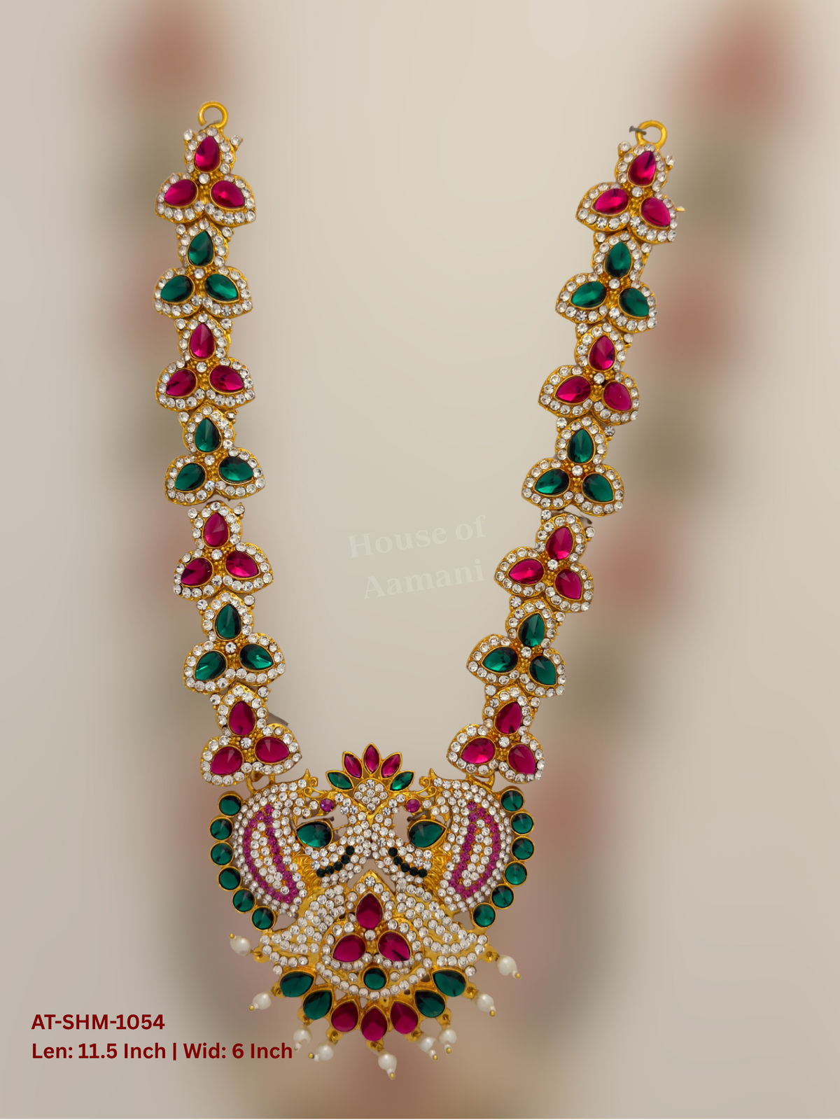 Elevate your deity alankaram with our traditional gold-plated 11.5-inch Swamy Haram with Fuchsia Pink, Green, White Coloured Stones.