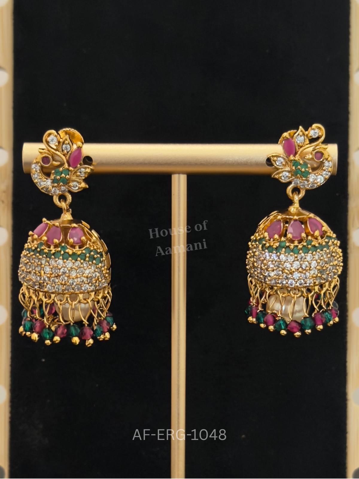 Peacock studs with jewelled plumes top a dome of ruby petals and emerald and crystal bands, finished with ruby-green beads.