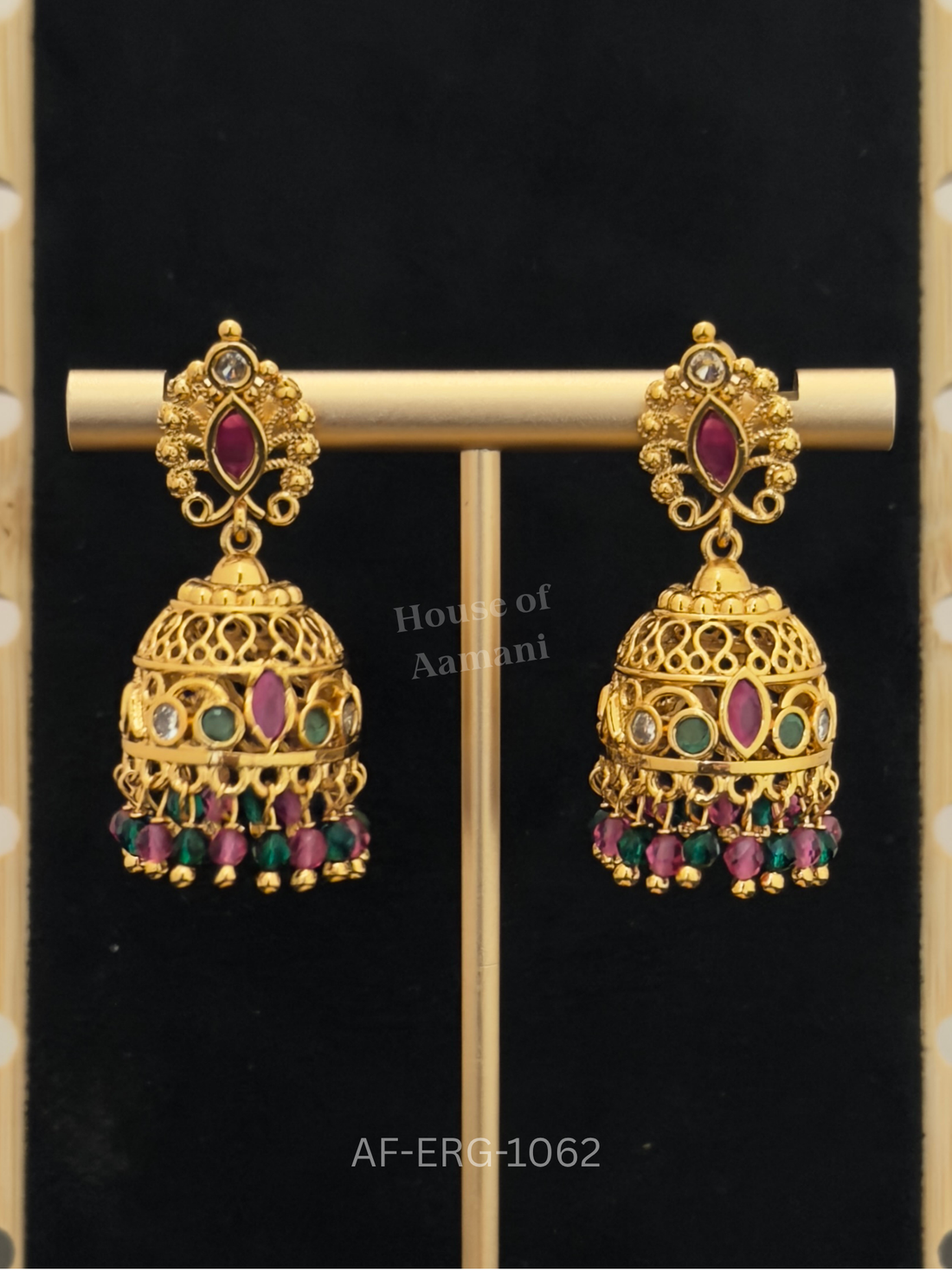 Filigree cutwork domes with a ruby marquise centre and emerald accents, finished with ruby-green bead drops.