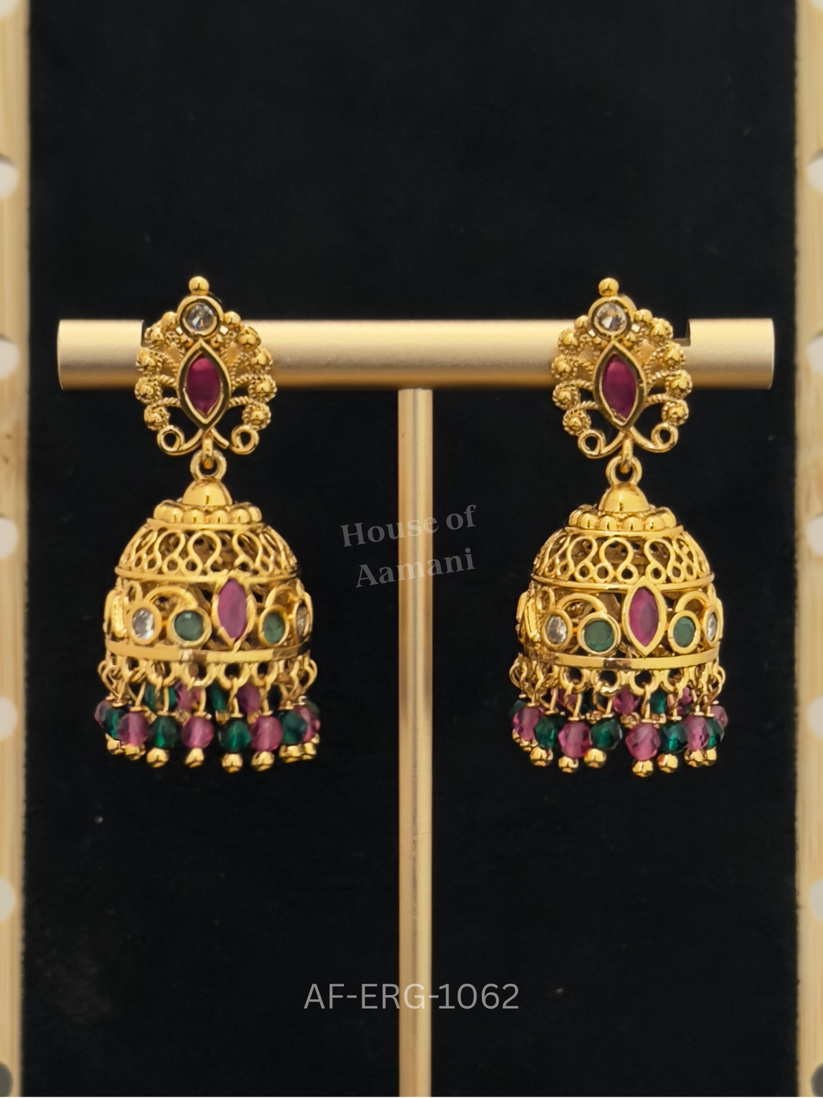 Filigree cutwork domes with a ruby marquise centre and emerald accents, finished with ruby-green bead drops.