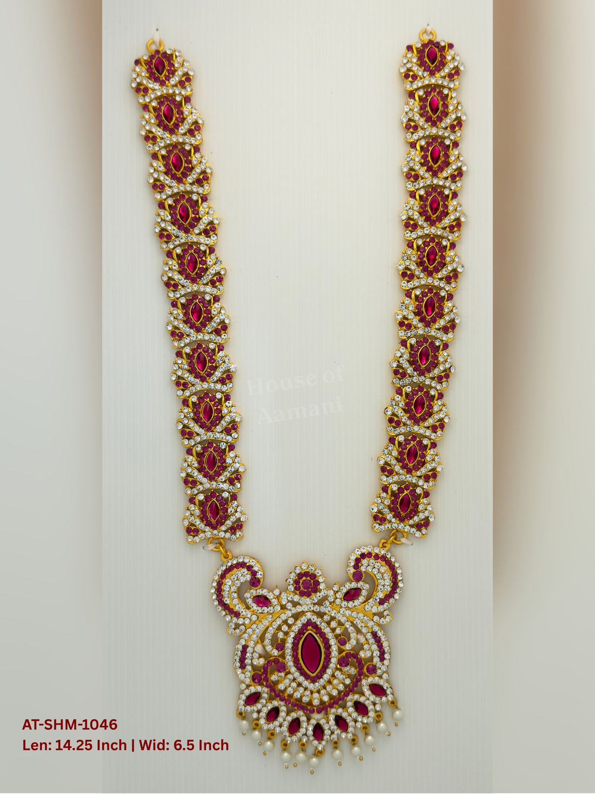 Elevate your deity alankaram with our traditional gold-plated 14.25-inch Swamy Haram with Fuchsia Pink, White Coloured Stones.