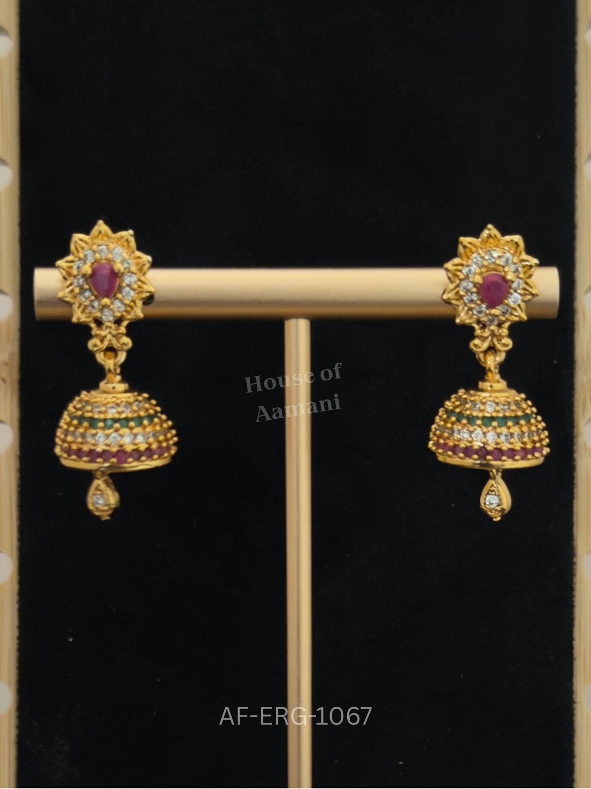 Compact jhumkas with a crystal sunburst top and a dome of ruby, emerald, and white stone bands, ending in a dainty teardrop.
