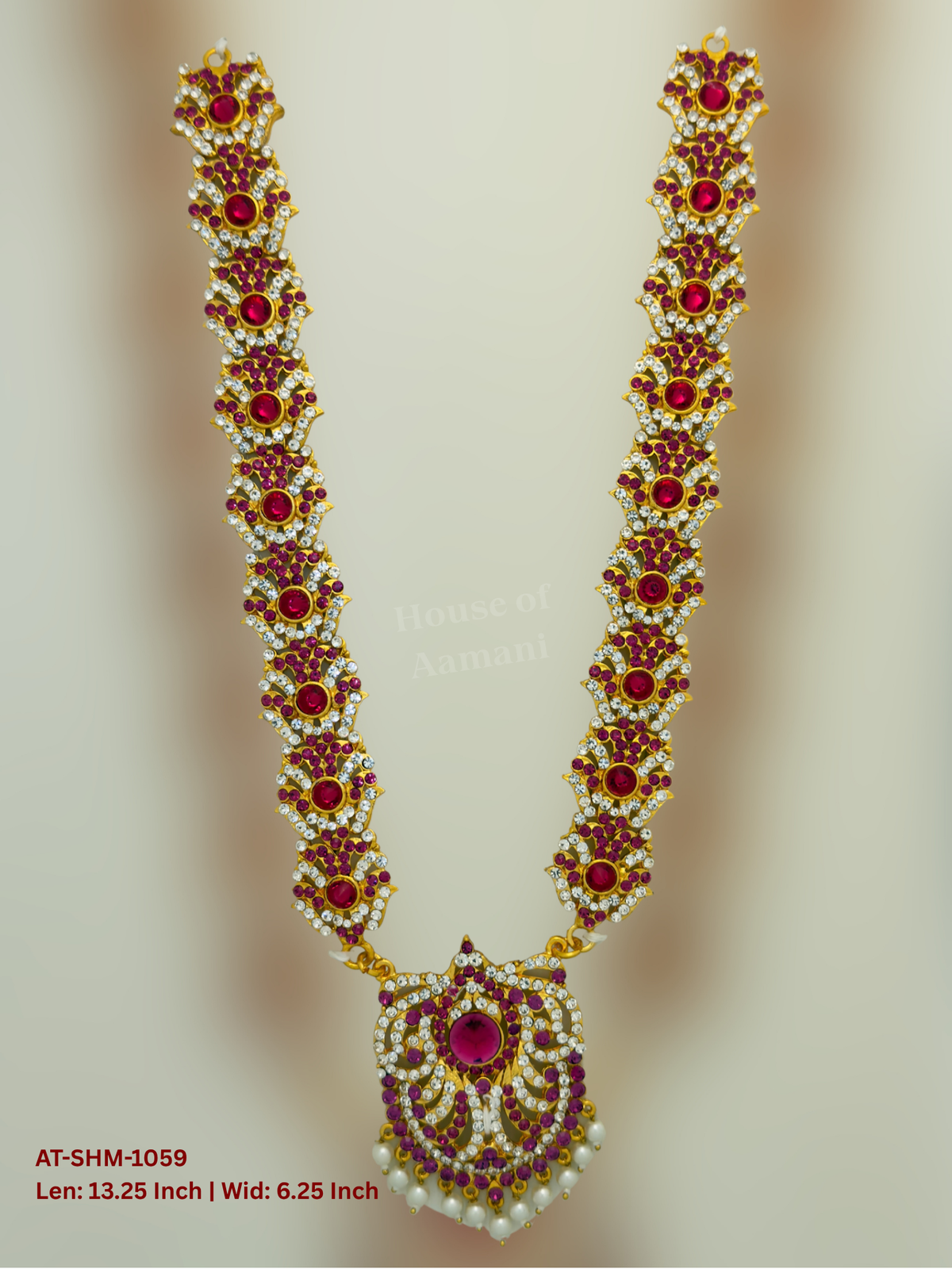 Elevate your deity alankaram with our traditional gold-plated 13.25-inch Swamy Haram with Fuchsia Pink, White Coloured Stones.