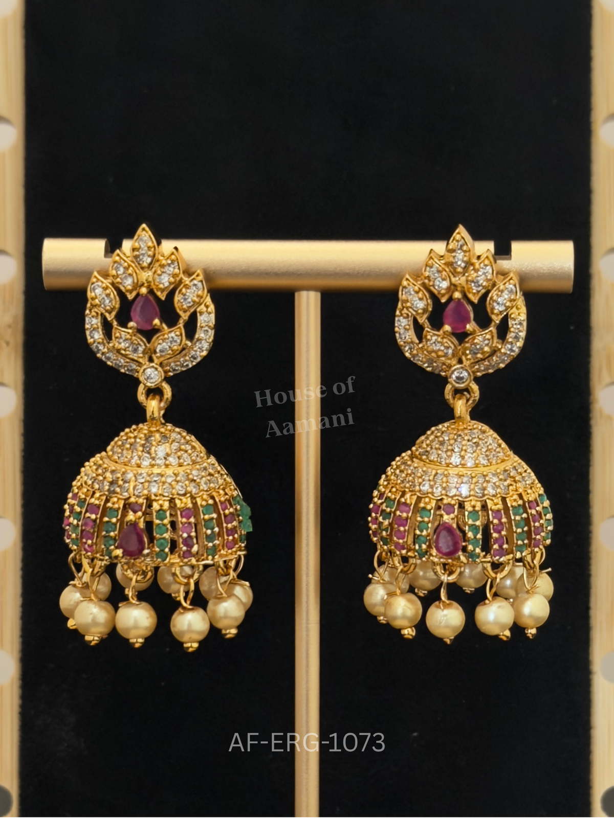 Sparkling crystal leaf tops lead to a jewelled cage dome of ruby and emerald bars, finished with cream pearl drops.
